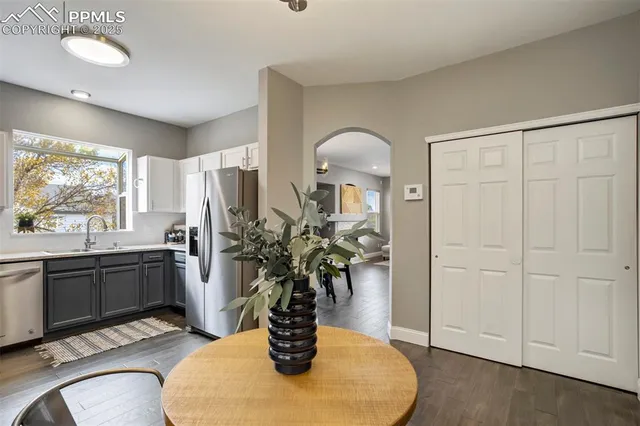 a kitchen with stainless steel appliances granite countertop a potted plant on the counter and sink