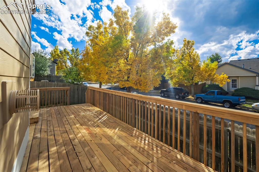 3140 River Valley View Colorado Springs, CO 80922 - Photo 43 of 49 a view of balcony with wooden floor and fence