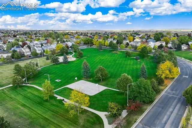 an aerial view of multiple houses with yard