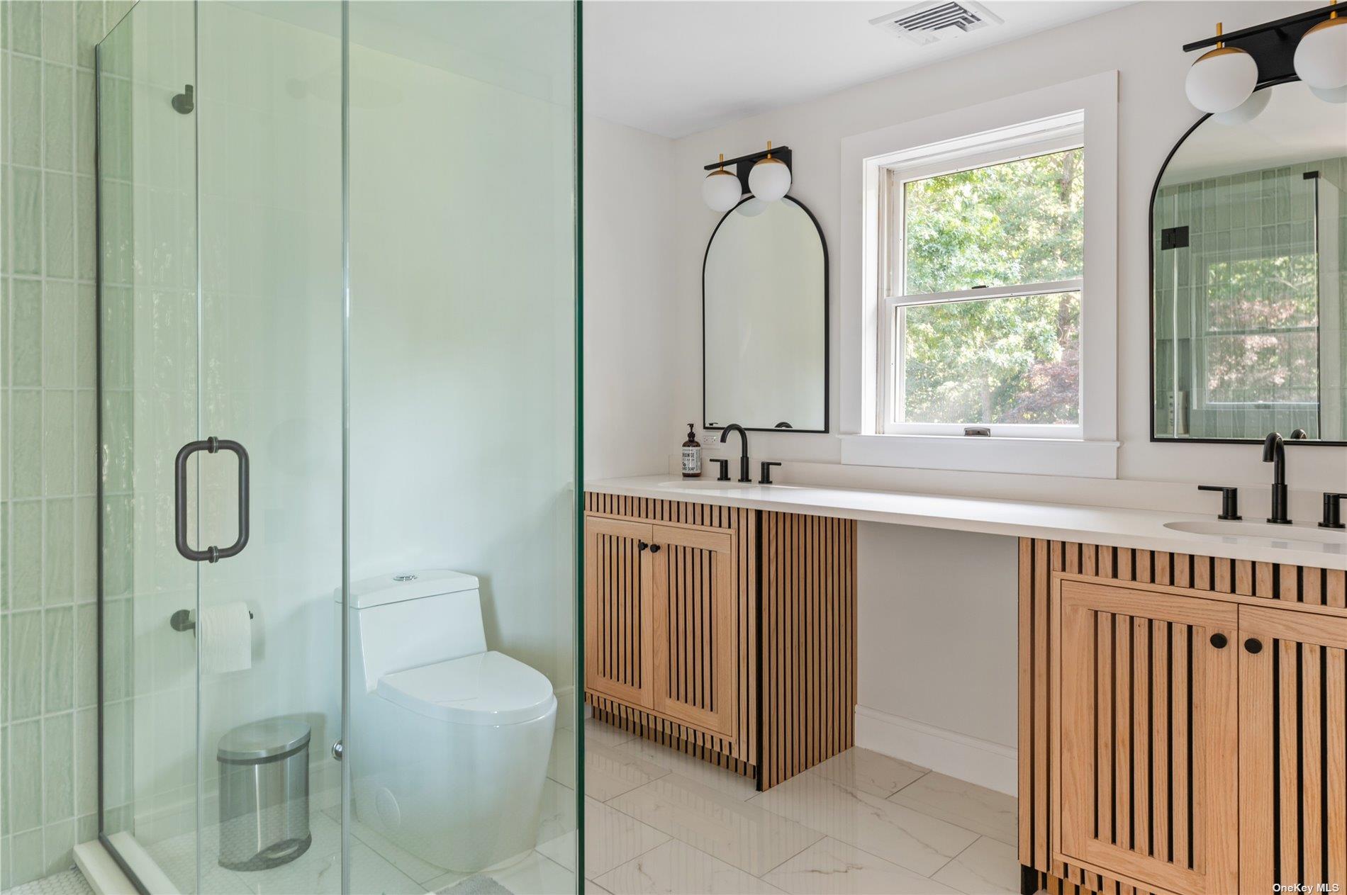 870 Stars Road East Marion, NY 11939 - Photo 21 of 23 a bathroom with a double vanity sink a toilet and a mirror