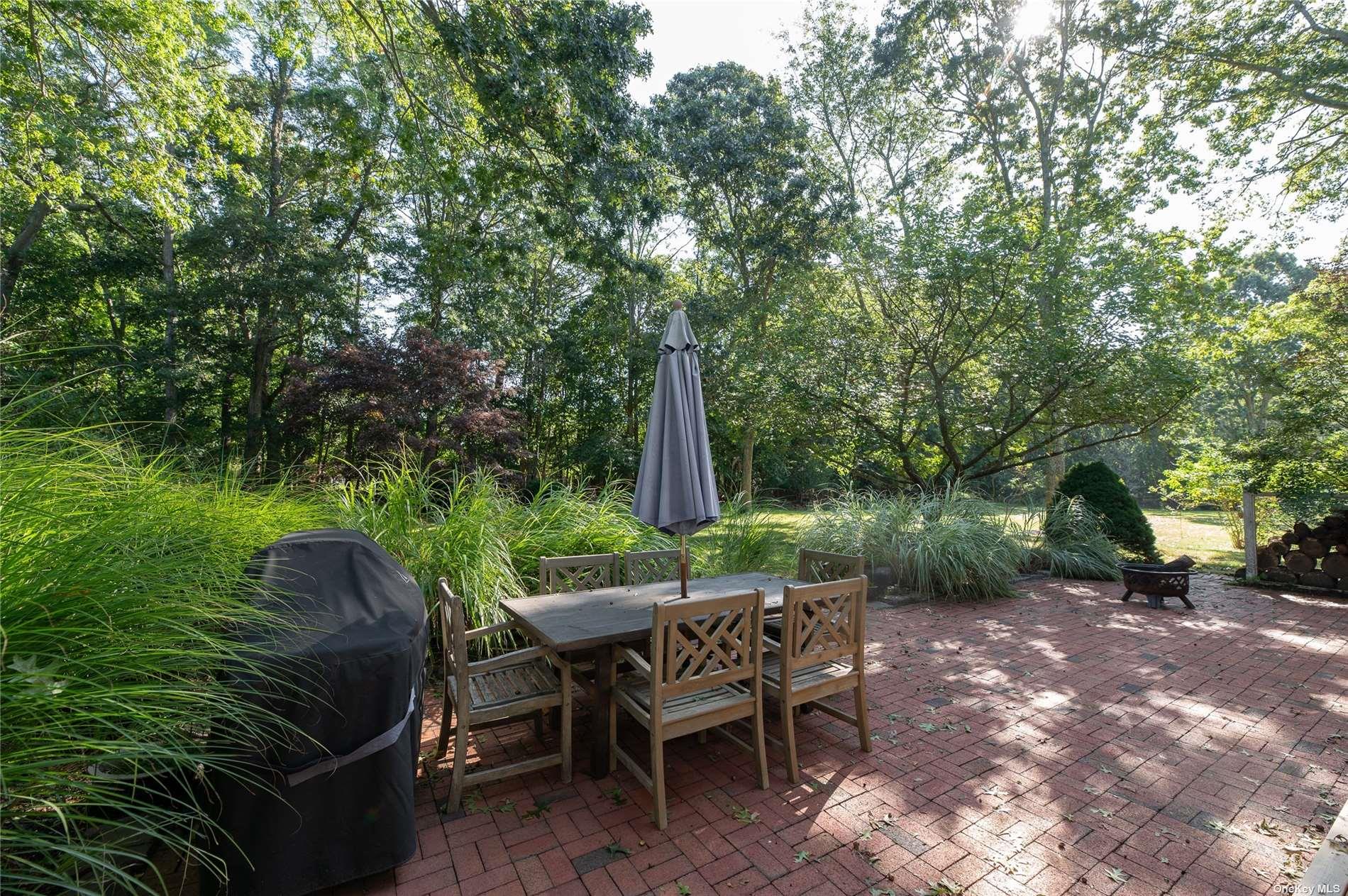 870 Stars Road East Marion, NY 11939 - Photo 22 of 23 a view of backyard with outdoor seating and green space