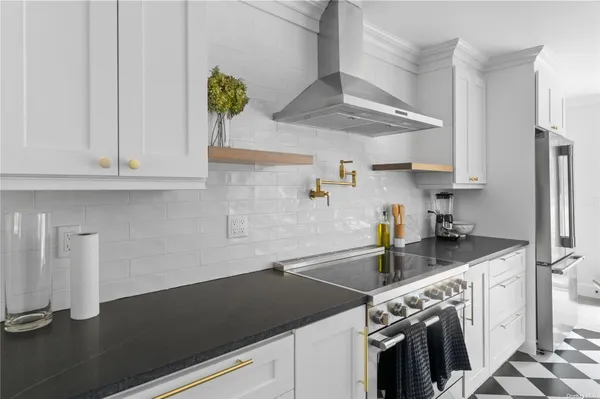 a kitchen with a sink a stove and cabinets