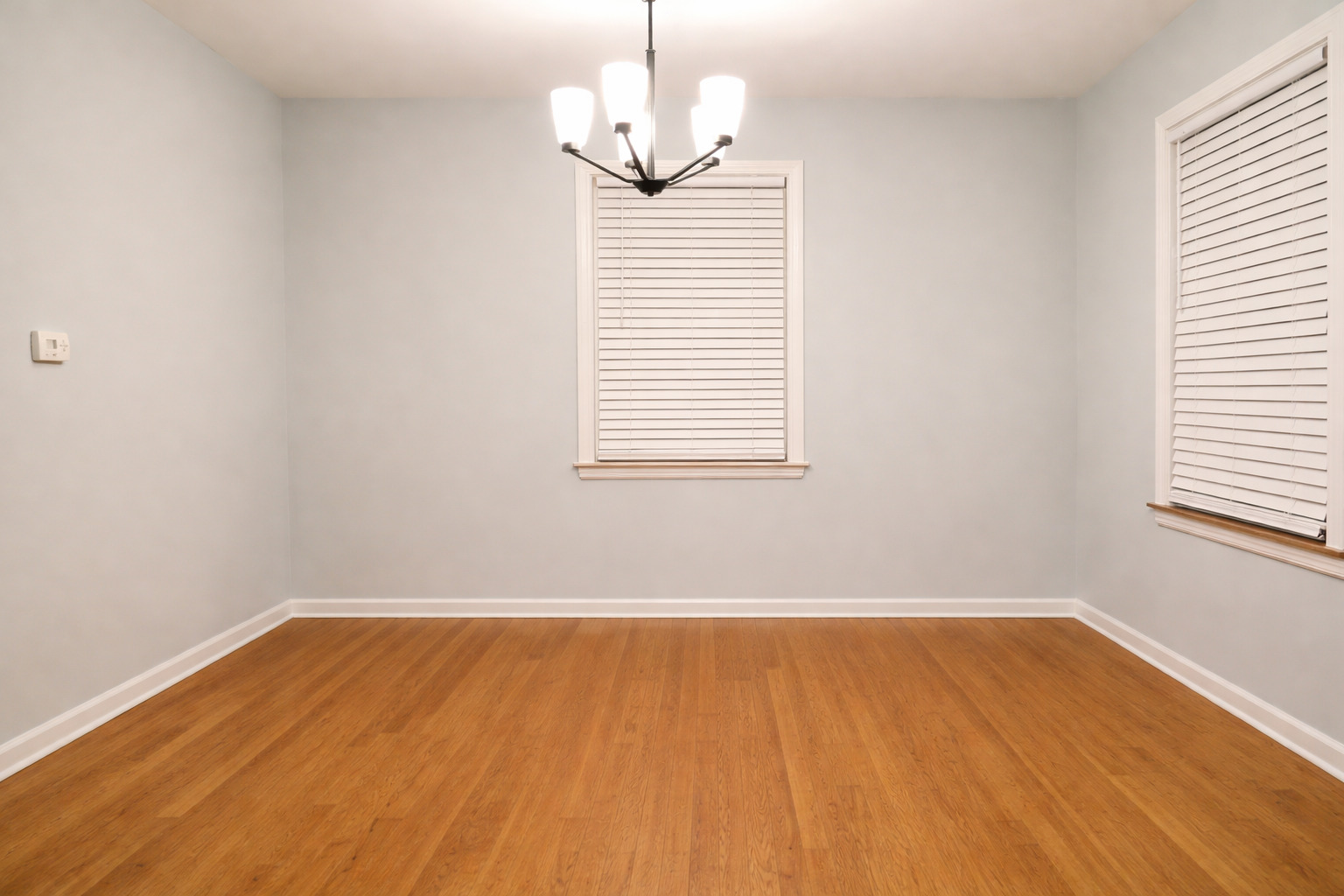 9044 South Merrill Avenue Chicago, IL 60617 - Photo 15 of 46 a view of a room with wooden floor and windows