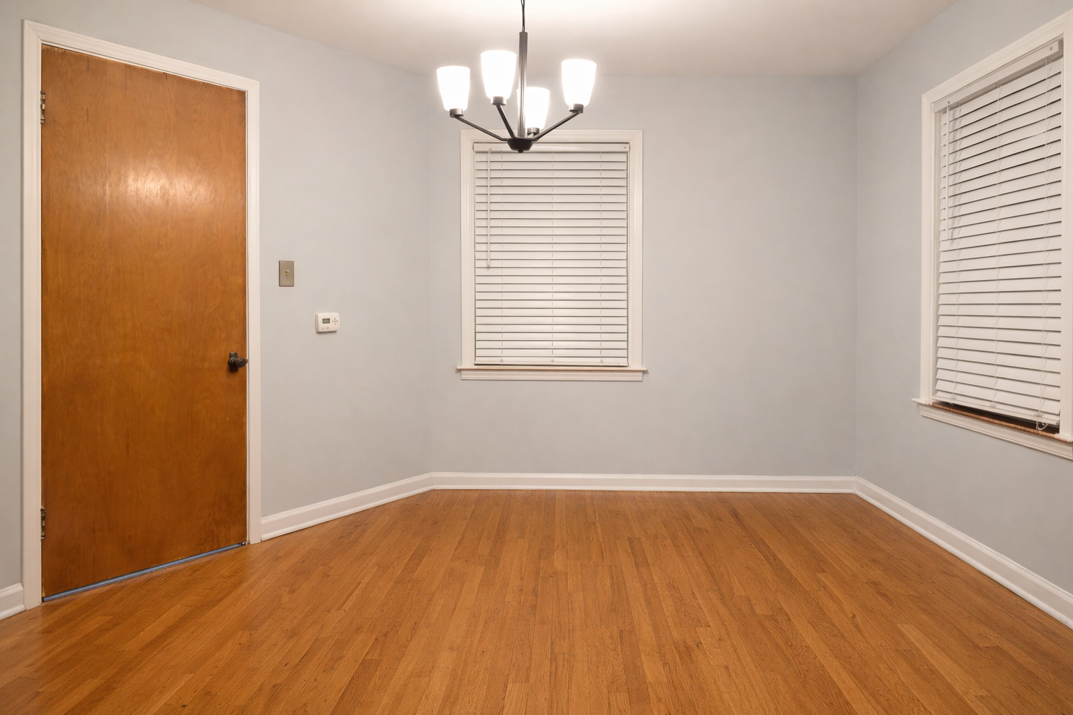 9044 South Merrill Avenue Chicago, IL 60617 - Photo 18 of 46 a view of an empty room with wooden floor and a window