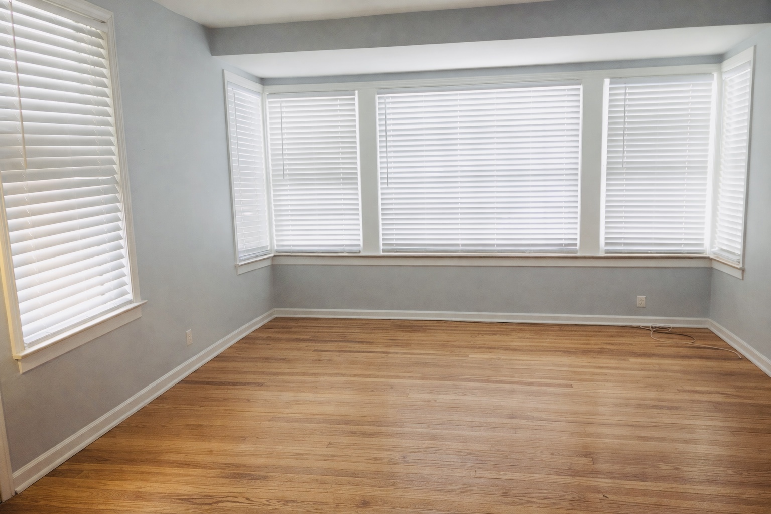 9044 South Merrill Avenue Chicago, IL 60617 - Photo 22 of 46 a view of an empty room with wooden floor and a window