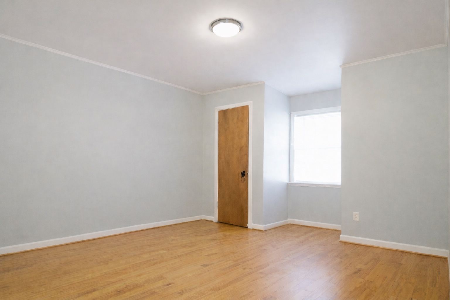 9044 South Merrill Avenue Chicago, IL 60617 - Photo 29 of 46 an empty room with wooden floor and windows