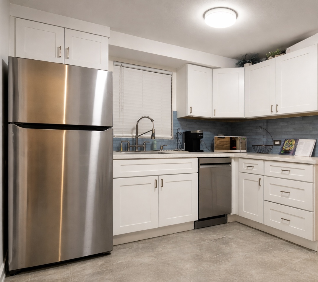 9044 South Merrill Avenue Chicago, IL 60617 - Photo 3 of 46 a kitchen with cabinets and white stainless steel appliances