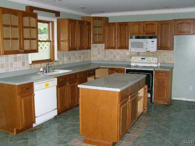 3448 Quarry Street Whitehall, PA 18052 - Photo 6 of 17 a kitchen with a stove sink and cabinets