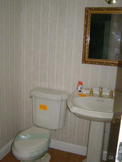 3448 Quarry Street Whitehall, PA 18052 - Photo 8 of 17 a bathroom with a sink toilet and mirror