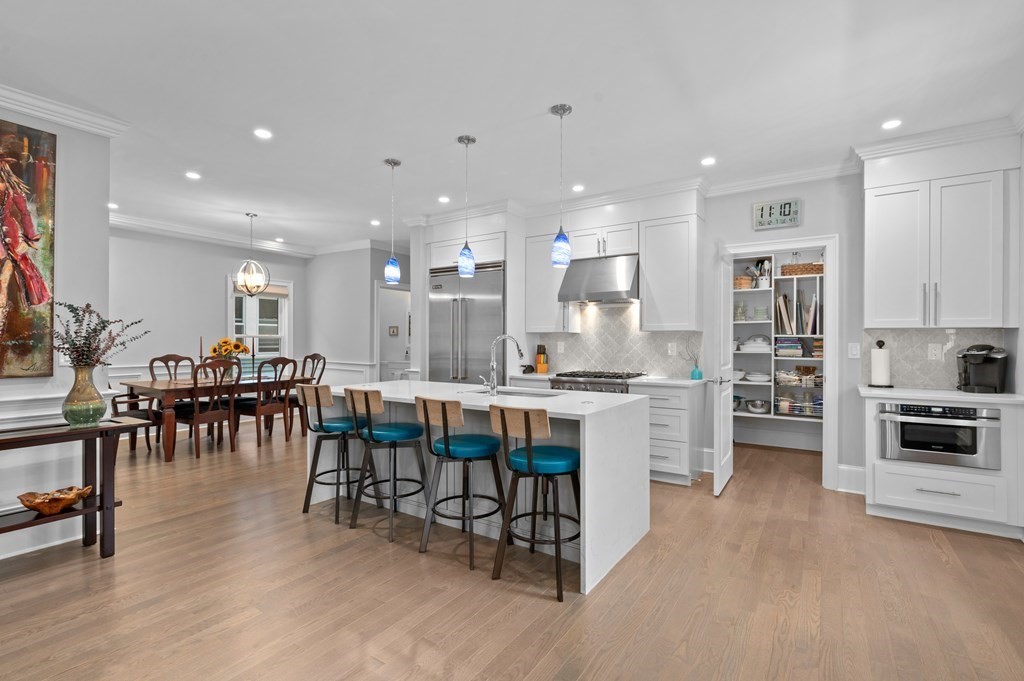 a large kitchen with lots of counter top space and stainless steel appliances