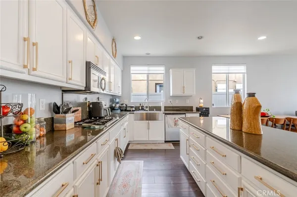 a kitchen with sink a stove and cabinets