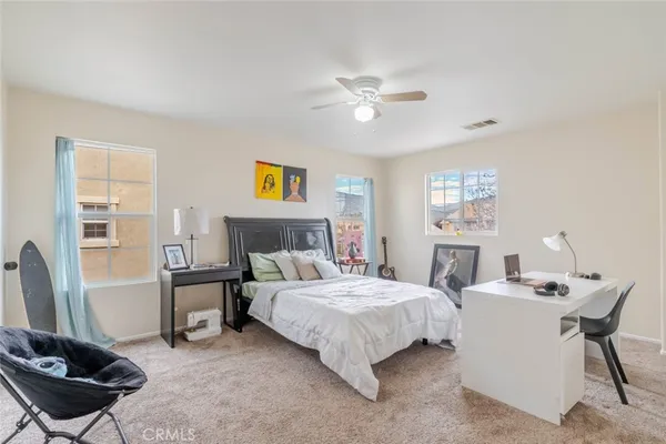 a bedroom with a bed a couch and a window