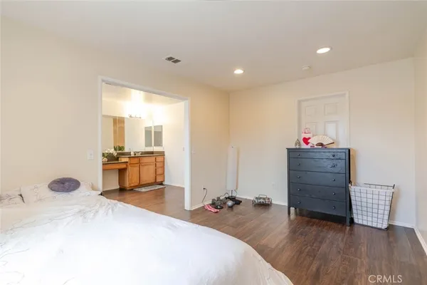 a bedroom with a bed and a view of living room