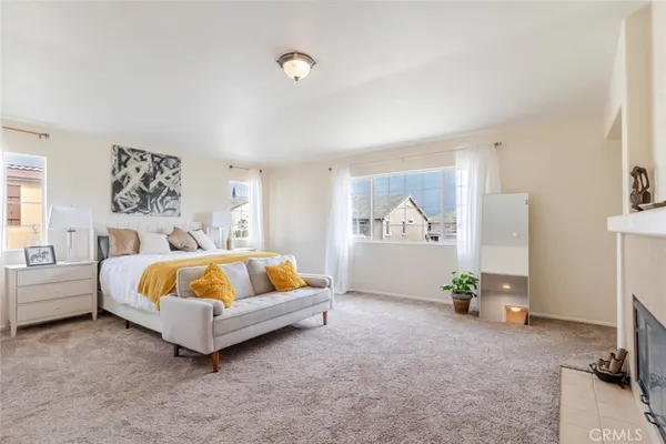 a spacious bedroom with a bed and a couch