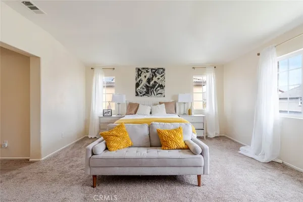 a bedroom with a bed and window