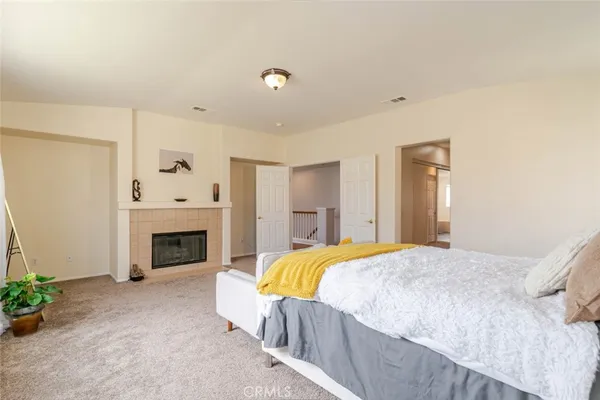 a bedroom with a bed and a fireplace