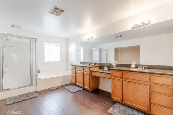 a large kitchen with a lot of cabinets and wooden floor