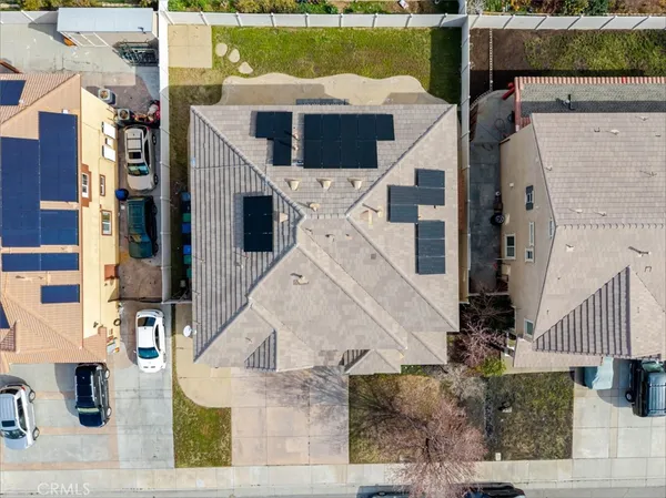 an aerial view of a house with a yard