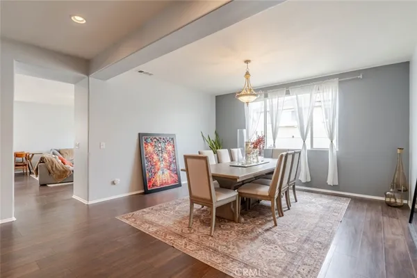 a dining room with furniture and wooden floor