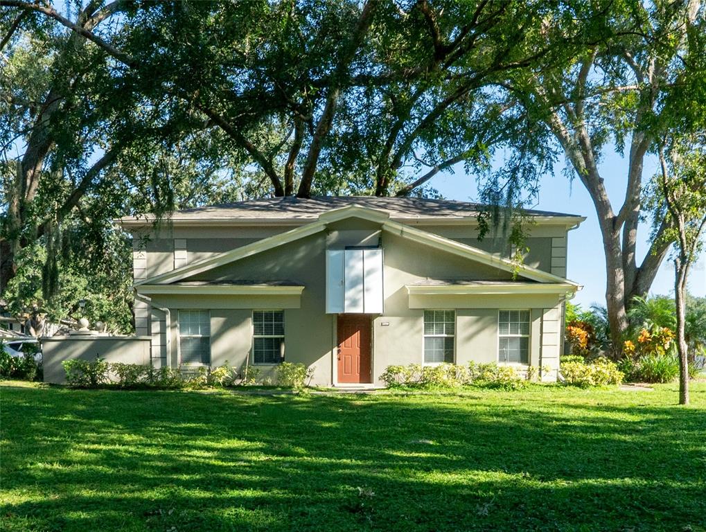 a front view of a house with a garden