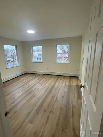 a view of room with window and hardwood floor