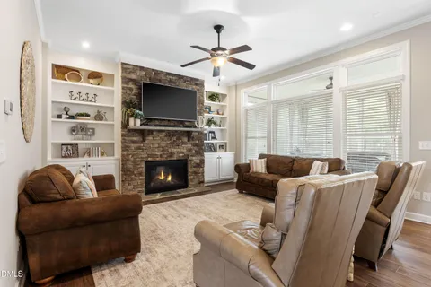 a living room with furniture kitchen area and a window