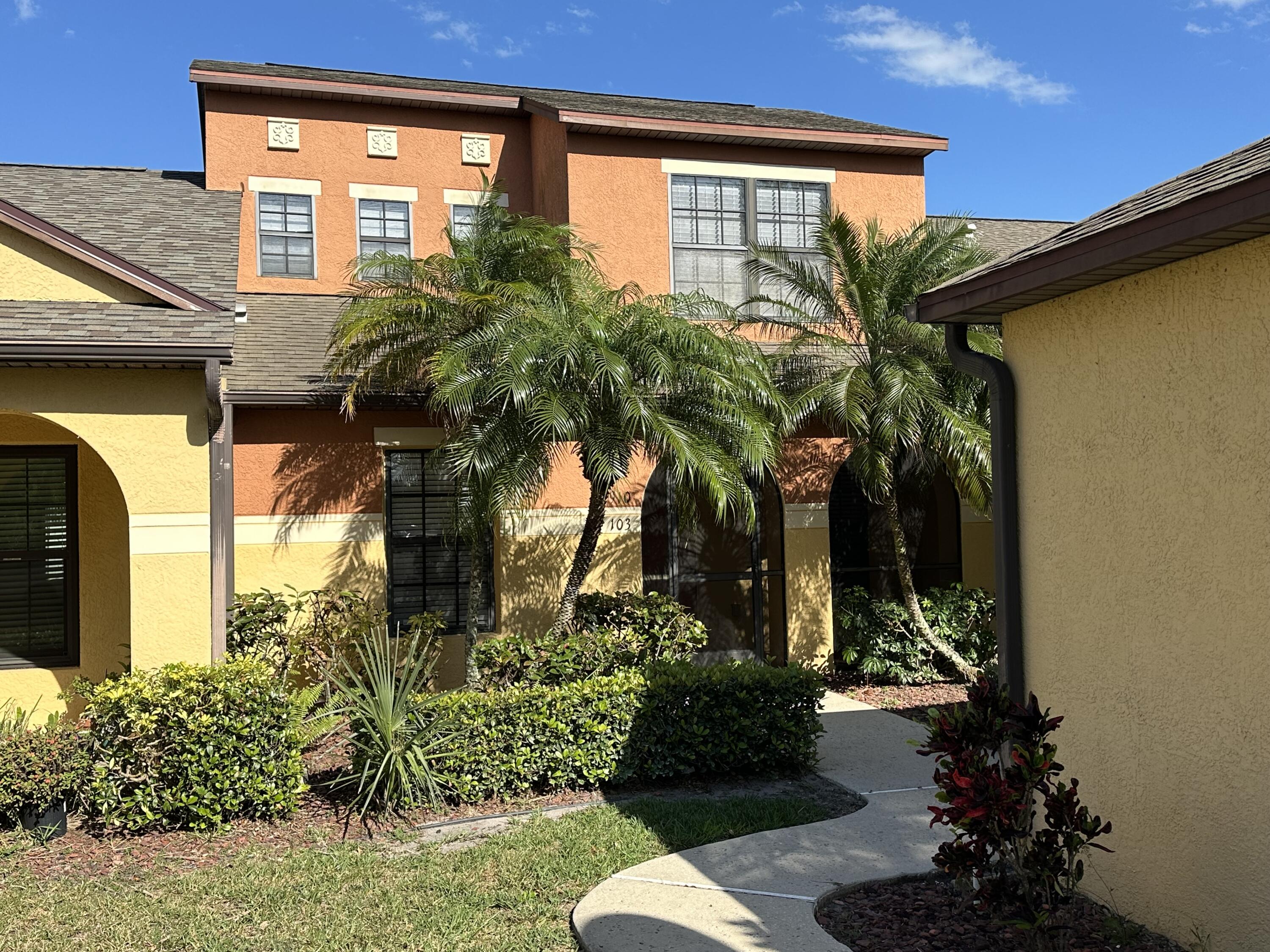 910 Luminary Circle, Unit 103 Melbourne, FL 32901 - Photo 2 of 31 a couple of potted plants in front of door