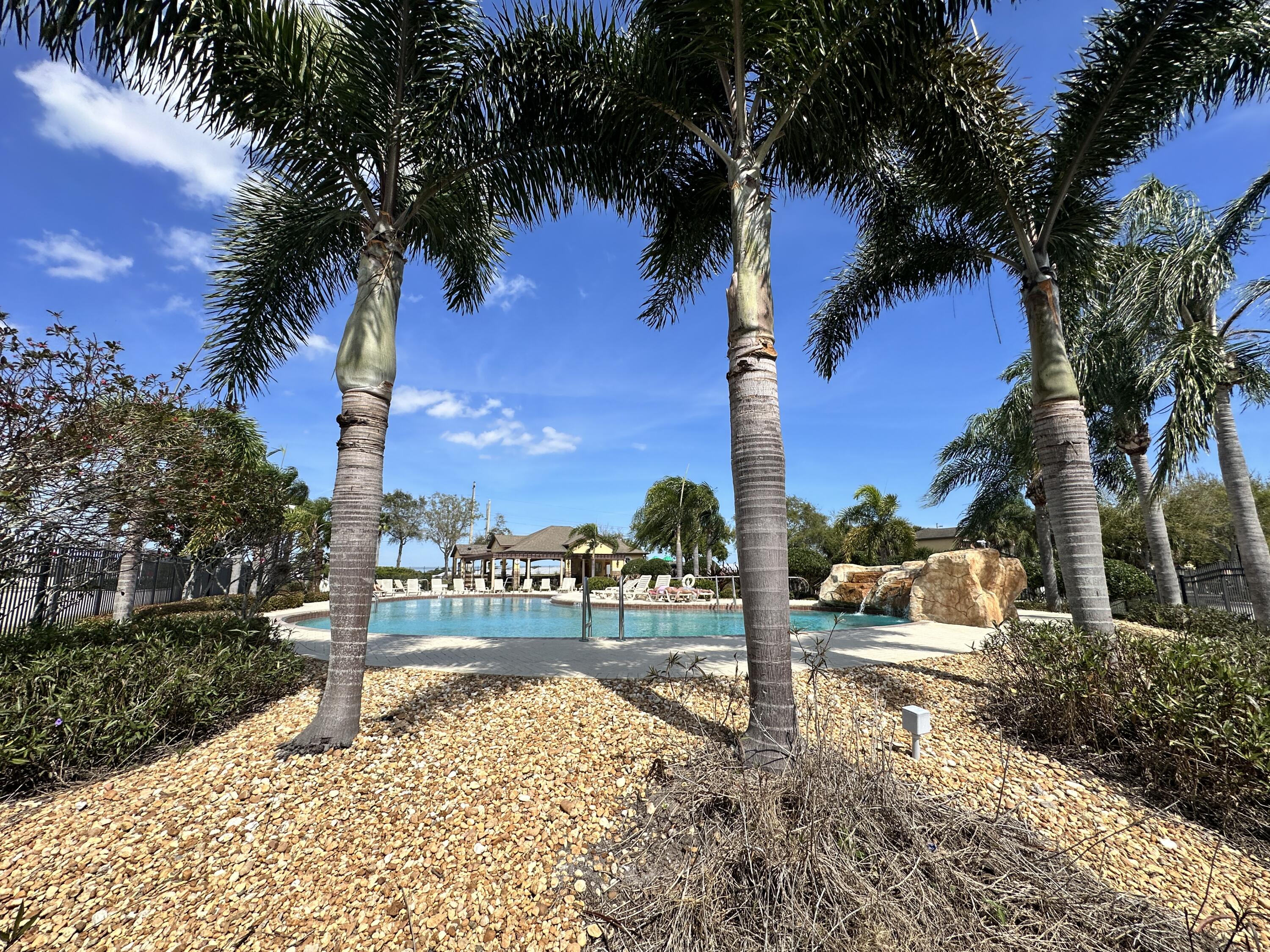 910 Luminary Circle, Unit 103 Melbourne, FL 32901 - Photo 28 of 31 a view of a yard with palm tree