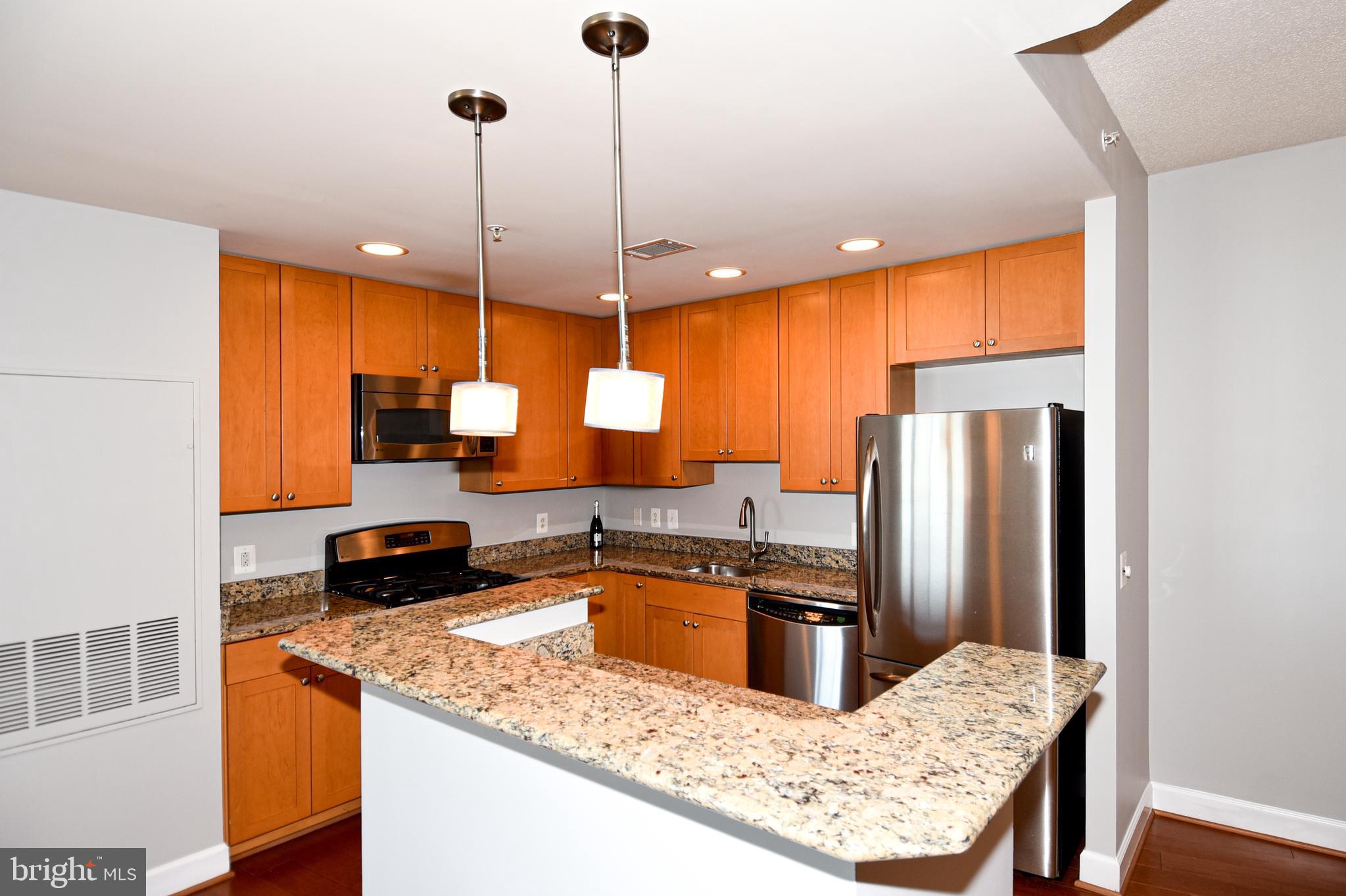 3650 South Glebe Road, Unit 662 Arlington, VA 22202 - Photo 11 of 63 a kitchen with stainless steel appliances granite countertop sink stove and refrigerator