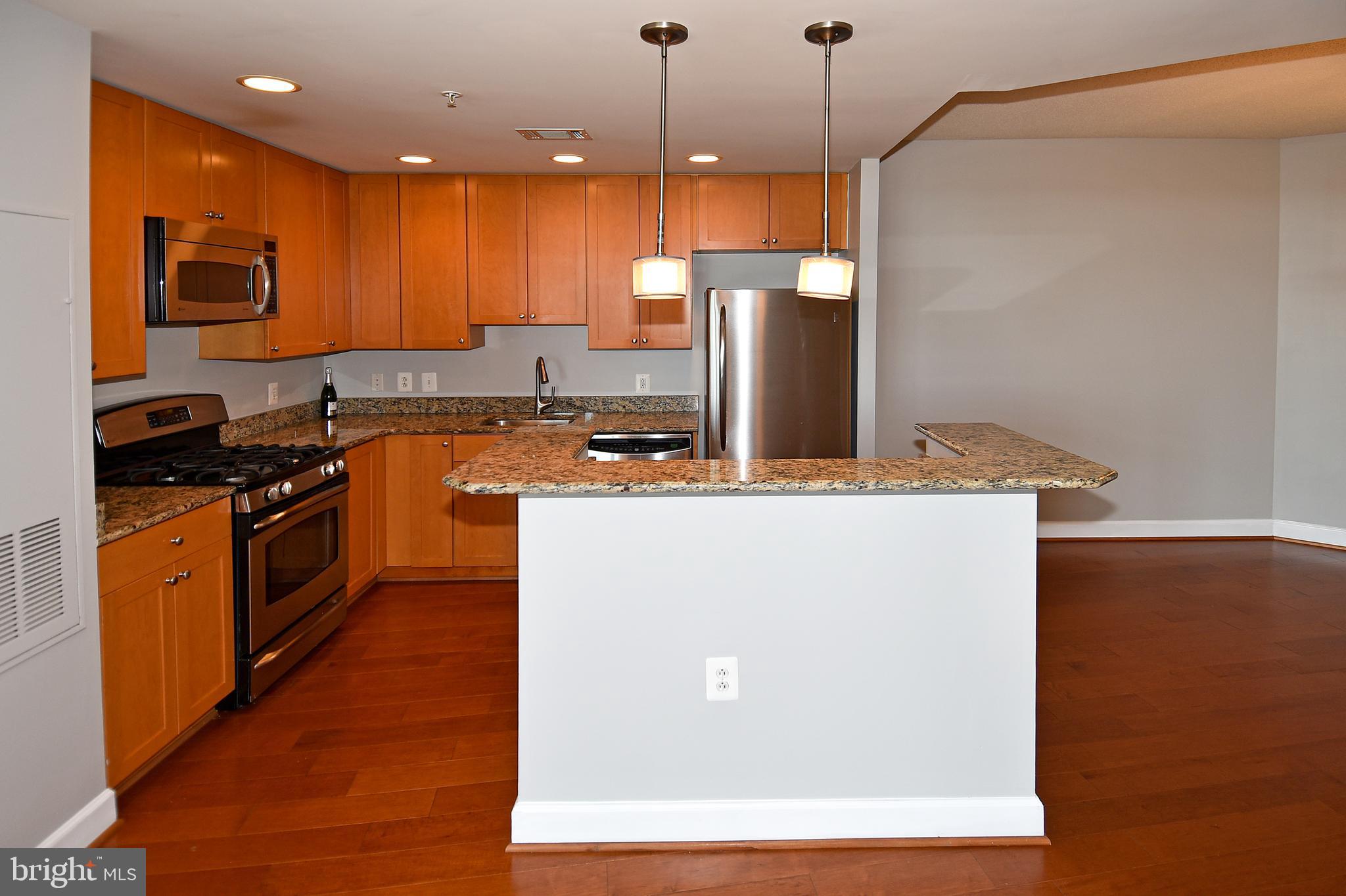 3650 South Glebe Road, Unit 662 Arlington, VA 22202 - Photo 12 of 63 a kitchen with stainless steel appliances granite countertop a sink a stove and a refrigerator