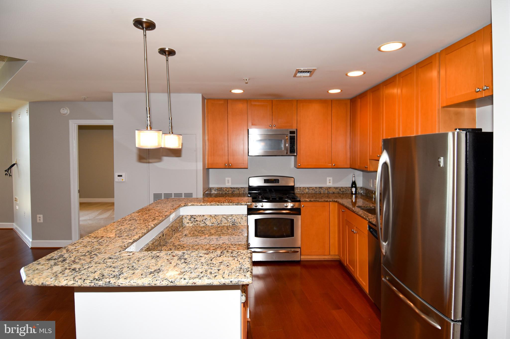 3650 South Glebe Road, Unit 662 Arlington, VA 22202 - Photo 13 of 63 a kitchen with stainless steel appliances granite countertop sink stove refrigerator and cabinets