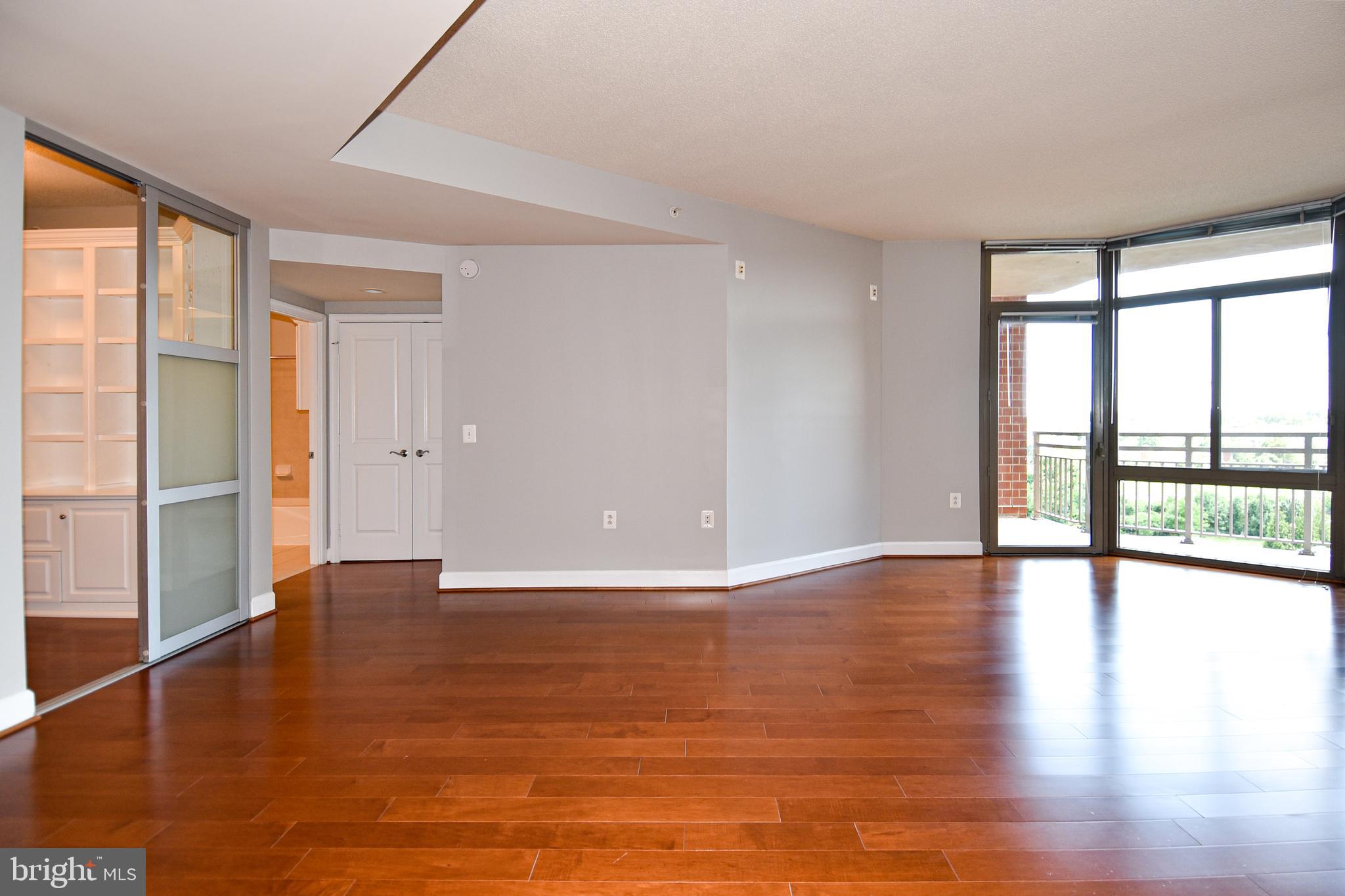 3650 South Glebe Road, Unit 662 Arlington, VA 22202 - Photo 15 of 63 a view of an empty room with window and wooden floor