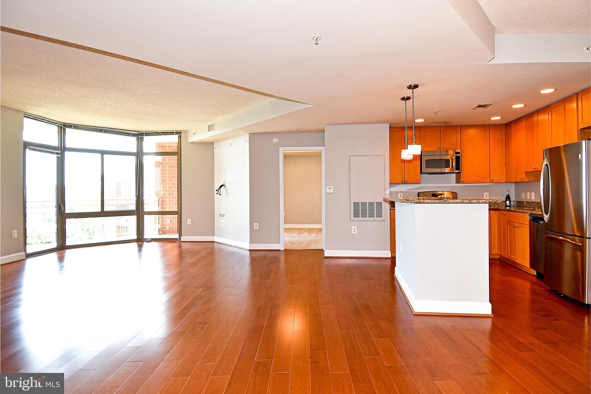 3650 South Glebe Road, Unit 662 Arlington, VA 22202 - Photo 6 of 63 a view of a kitchen with stainless steel appliances wooden floor and a large window