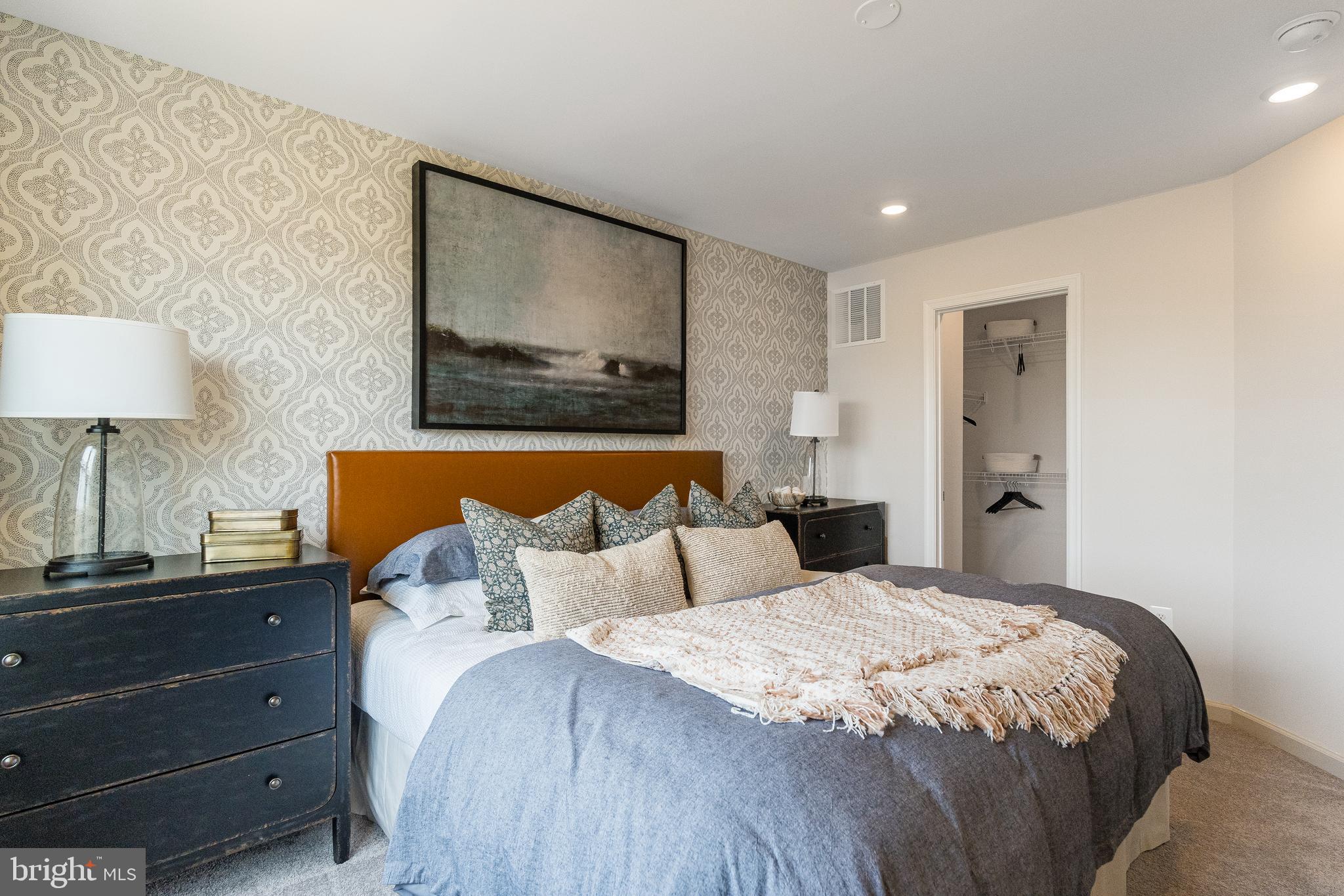 335 Sandy Btm Circle Ranson, WV 25438 - Photo 11 of 20 a bedroom with a bed and a lamp on dresser