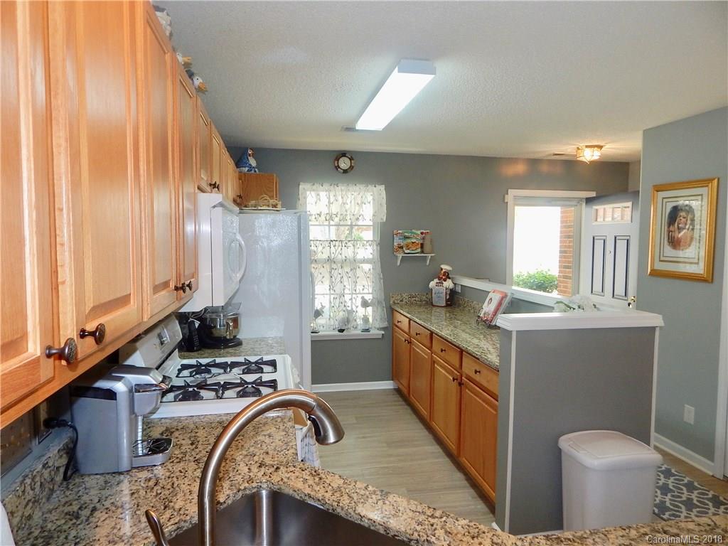 16720 Timber Crossing Road Charlotte, NC 28213 - Photo 5 of 33 a kitchen with a sink stove and cabinets