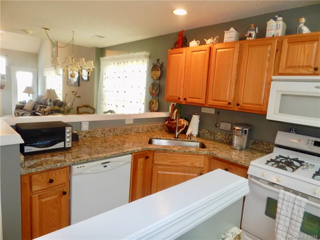 16720 Timber Crossing Road Charlotte, NC 28213 - Photo 6 of 33 a kitchen with a stove a sink and a microwave