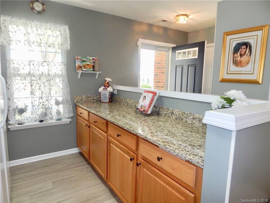 16720 Timber Crossing Road Charlotte, NC 28213 - Photo 8 of 33 a kitchen with granite countertop a sink and a window