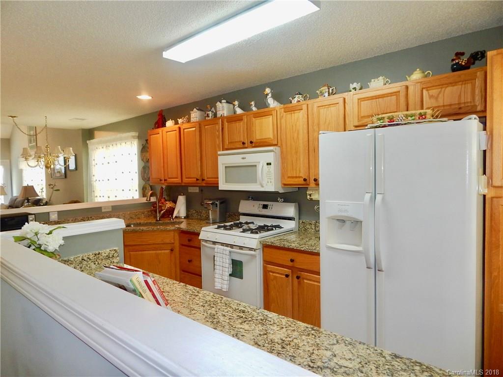 16720 Timber Crossing Road Charlotte, NC 28213 - Photo 10 of 33 a kitchen with stainless steel appliances granite countertop a refrigerator a stove and a sink with large countertops