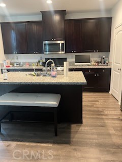 14255 Barolo Way Beaumont, CA 92223 - Photo 5 of 22 a kitchen with kitchen island granite countertop a sink and a stove