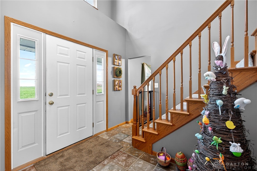 6560 Snyder Road Fletcher, OH 45326 - Photo 7 of 71 This inviting entryway features a grand staircase and durable tiled flooring.