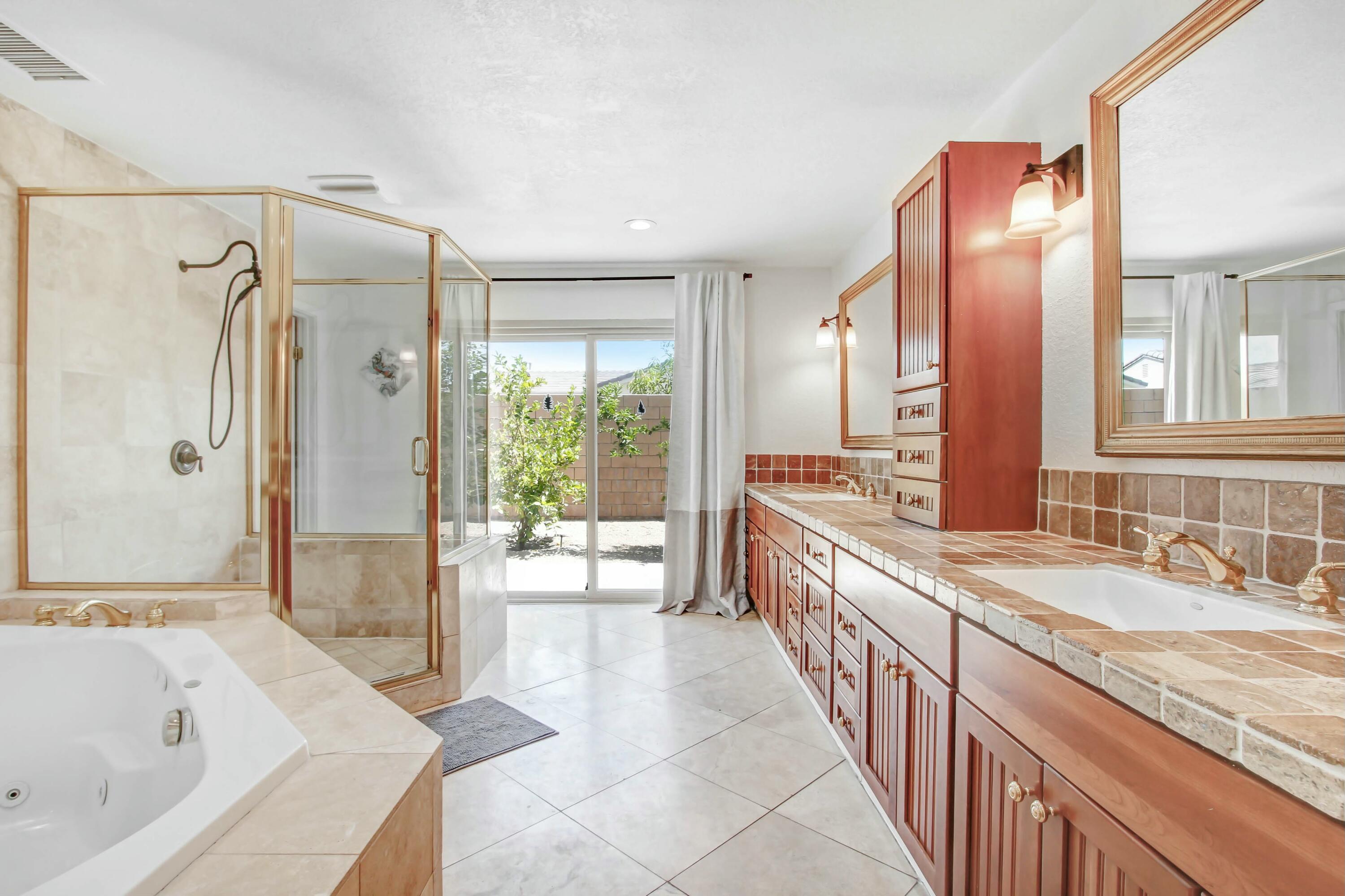 43480 Port Maria Road Bermuda Dunes, CA 92203 - Photo 13 of 24 a bathroom with a granite countertop tub sink and mirror