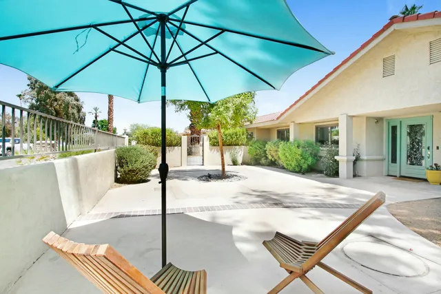 a view of a chair and table in the patio