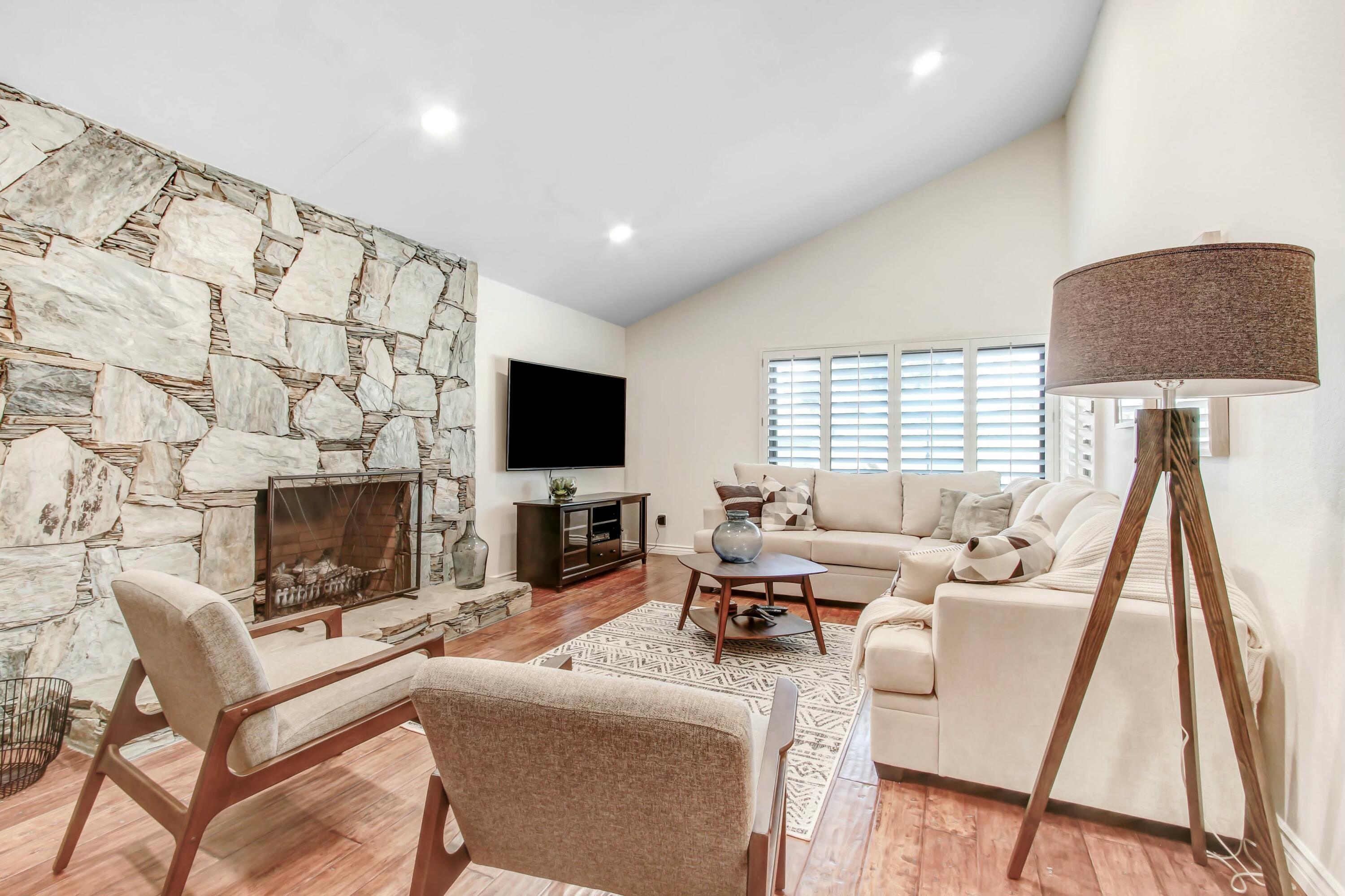 43480 Port Maria Road Bermuda Dunes, CA 92203 - Photo 6 of 24 a living room with furniture a flat screen tv and a fireplace