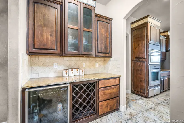 a view of a dining room with furniture a chandelier and wooden floor