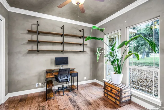 a view of a dining room with furniture large windows and wooden floor