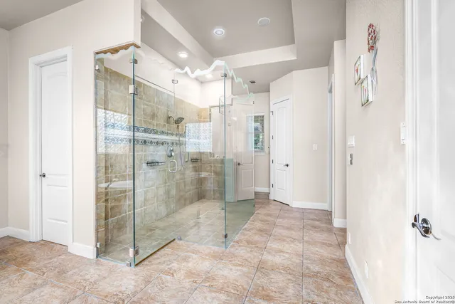 a view of a bathroom with a tub and shower