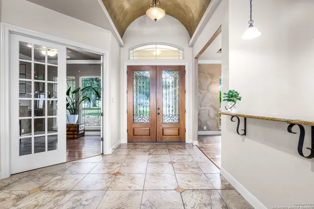 a living room with furniture or couches and a large window with garden view