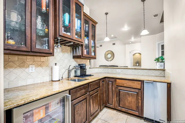 a kitchen with a sink and a table with chairs