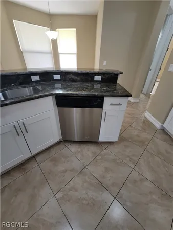 a kitchen with stainless steel appliances a sink stove and cabinets
