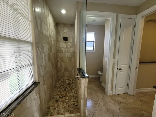 a bathroom with a shower and a sink
